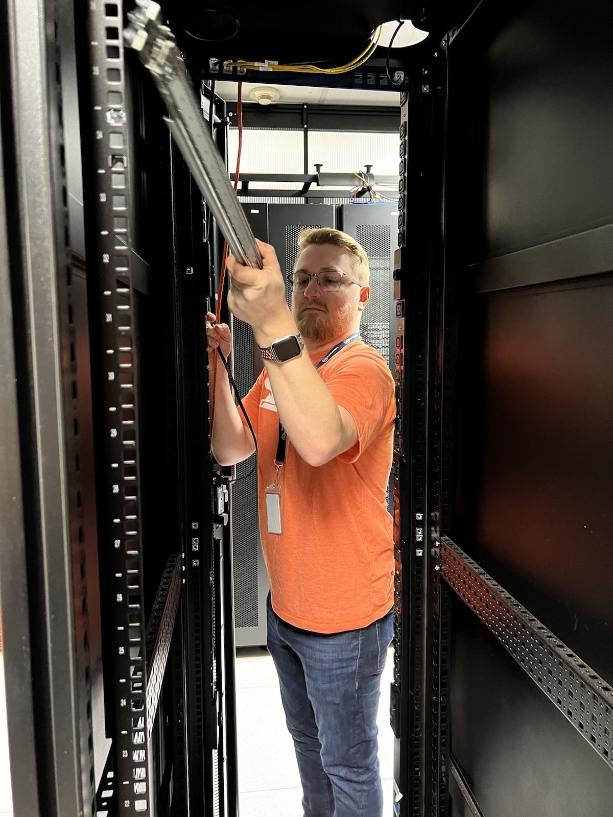 Scott working inside a server rack during Epoch Forge infrastructure setup