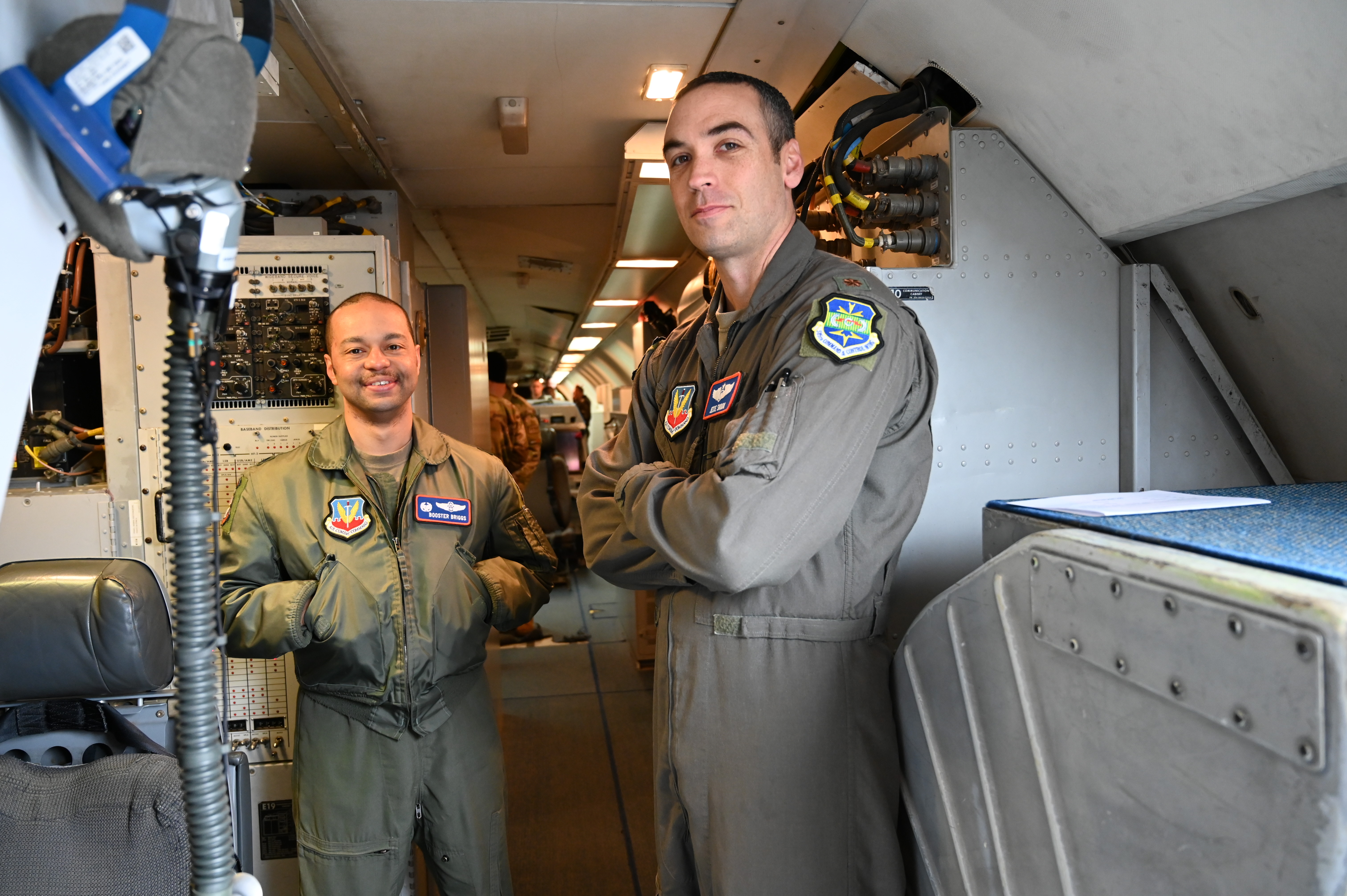Aircrew inside an AWACS aircraft supporting in-air electronic warfare update operations.